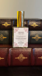 Back label of Maison of Stories Blank Page body oil 50ml with rococo floral corner details and unscented formula information, displayed on vintage leather-bound books