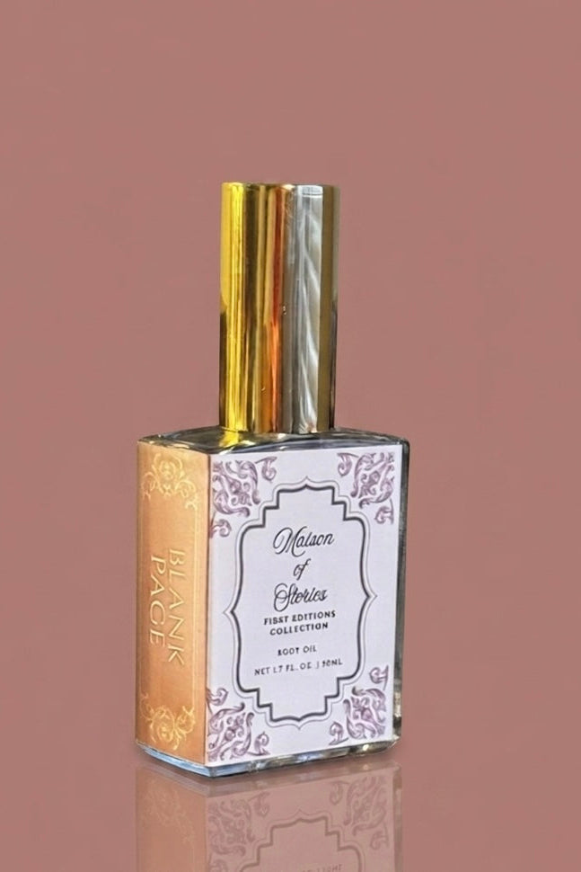 Clear glass bottle of Maison of Stories Blank Page body oil with gold cap against a dusty rose pink background