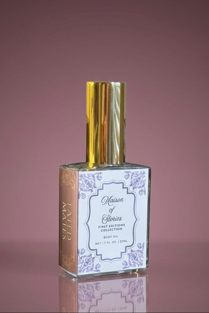 Maison of Stories Fated Mates body oil with gold cap against a dusty mauve background