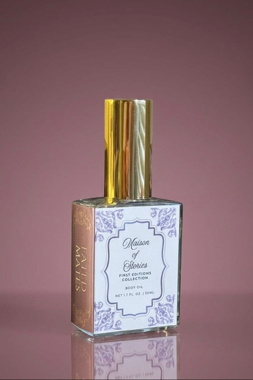 Maison of Stories Fated Mates body oil with gold cap against a dusty mauve background