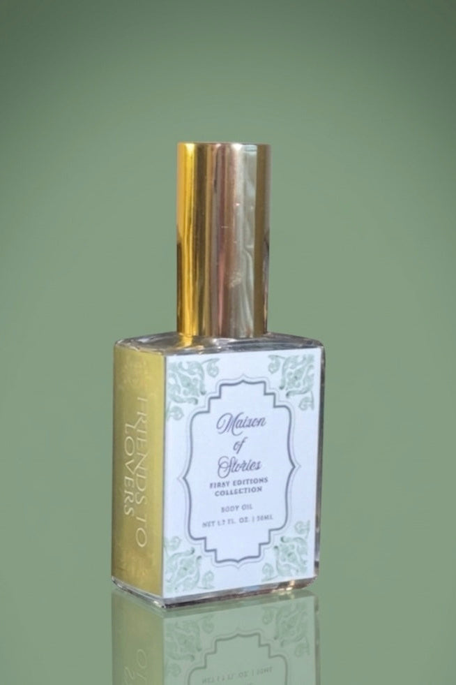 Maison of Stories Friends to Lovers body oil glass bottle with gold spray cap set against a muted green background