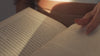 Lifestyle video of a woman reading, representing the romance fiction inspiration behind Maison of Stories fragrance collection